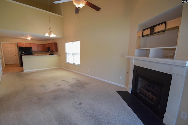 267 Courtside Dr, Lexington, SC 29073 - unfurnished living room featuring light carpet, a fireplace with flush hearth, a high ceiling, a ceiling fan, and a chandelier