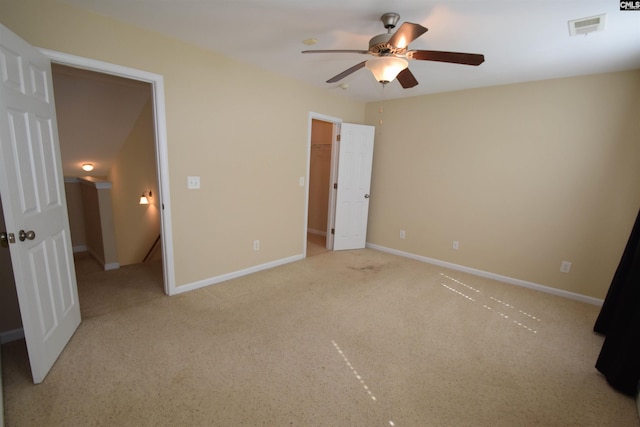 267 Courtside Dr, Lexington, SC 29073 - unfurnished bedroom with carpet, baseboards, a ceiling fan, and a walk in closet