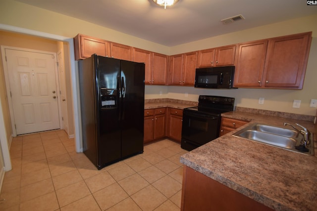 267 Courtside Dr, Lexington, SC 29073 - kitchen with black appliances, a sink, brown cabinetry, and light tile patterned floors