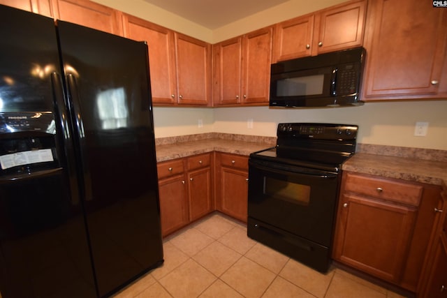267 Courtside Dr, Lexington, SC 29073 - kitchen featuring black appliances, brown cabinets, and light tile patterned floors