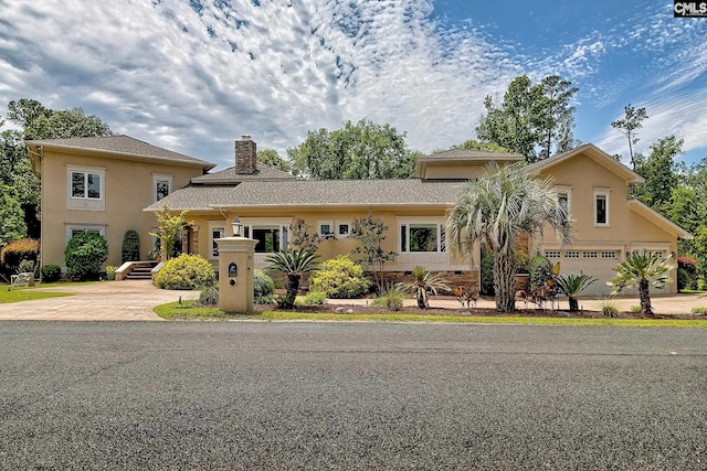 940 Willow Cove Rd, Chapin, SC 29036 - view of front of home with driveway, a chimney, a garage, and stucco siding