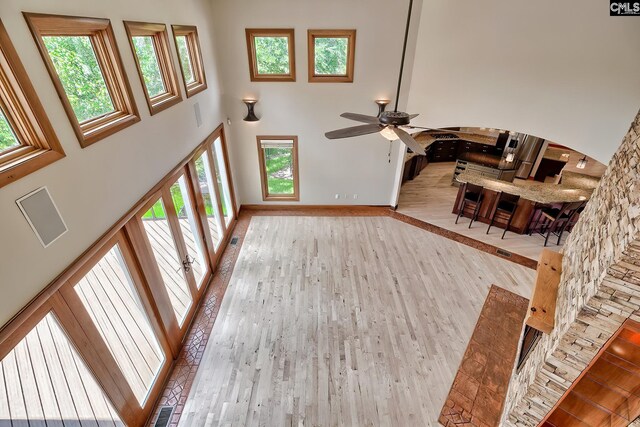 940 Willow Cove Rd, Chapin, SC 29036 - unfurnished living room featuring a high ceiling, a ceiling fan, and wood finished floors