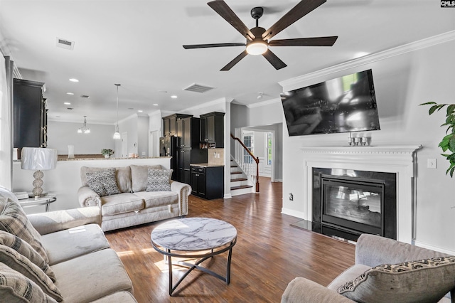 308 Bournemouth Way, Columbia, SC 29229 - living room featuring crown molding, a ceiling fan, wood finished floors, a glass covered fireplace, and recessed lighting