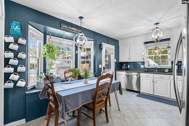 336 S Royal Tower Dr, Irmo, SC 29063 - dining room featuring a chandelier, plenty of natural light, a textured ceiling, and light tile patterned flooring