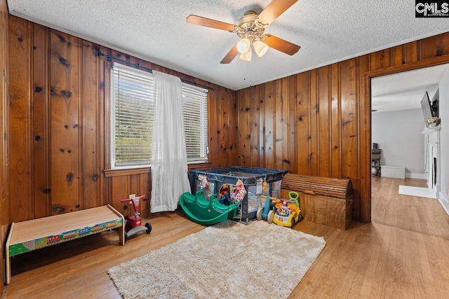 26 Carroll Ct, West Columbia, SC 29170 - rec room featuring ceiling fan, wood finished floors, a textured ceiling, and wood walls