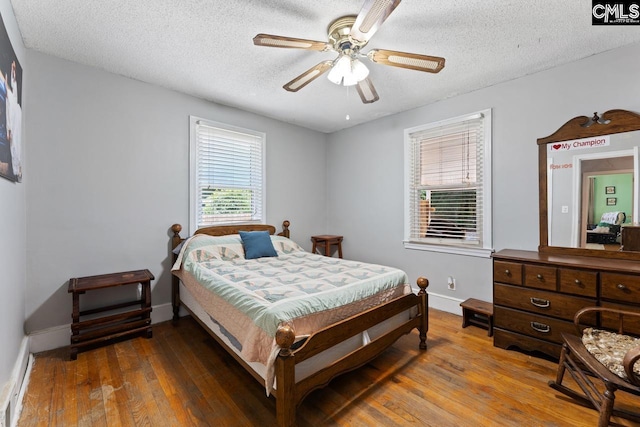 26 Carroll Ct, West Columbia, SC 29170 - bedroom with hardwood / wood-style floors, a textured ceiling, baseboards, and a baseboard heating unit