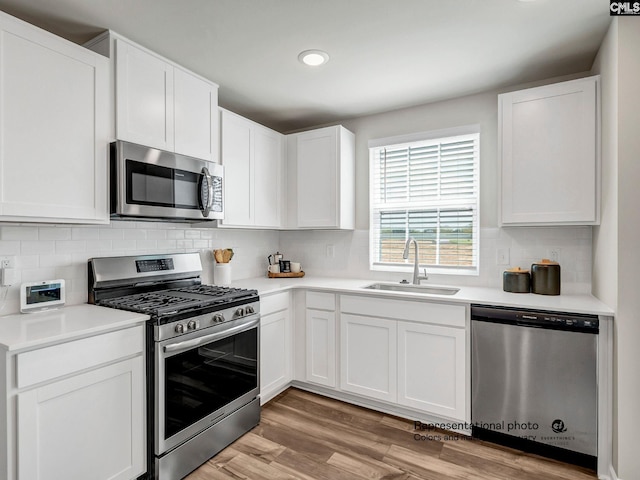 219 Bones Rd, Gilbert, SC 29054 - kitchen featuring stainless steel appliances, a sink, light countertops, white cabinets, and recessed lighting