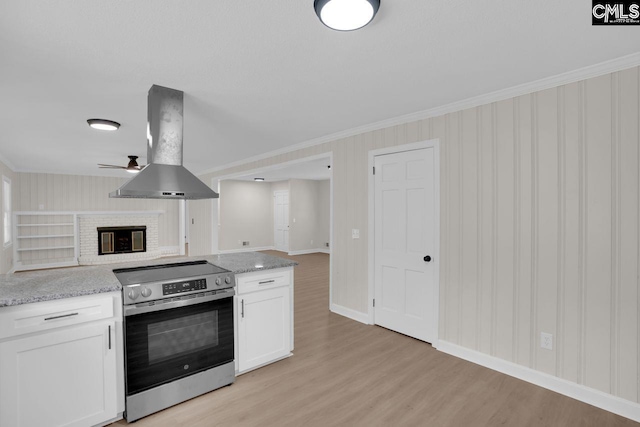 248 Shareditch Rd, Columbia, SC 29210 - kitchen with stainless steel range with electric stovetop, island range hood, light wood-style flooring, white cabinetry, and baseboards