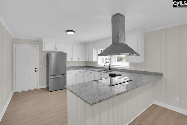 248 Shareditch Rd, Columbia, SC 29210 - kitchen with freestanding refrigerator, a sink, island exhaust hood, light wood finished floors, and a peninsula