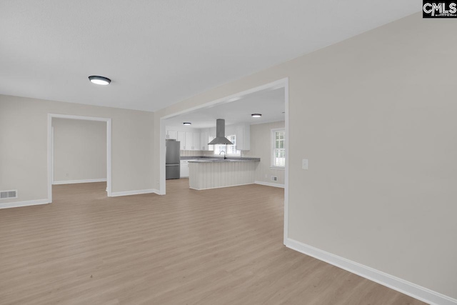 248 Shareditch Rd, Columbia, SC 29210 - unfurnished living room with a sink, light wood-style floors, and baseboards