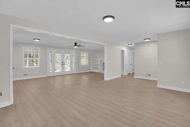 248 Shareditch Rd, Columbia, SC 29210 - unfurnished living room with light wood-style floors, baseboards, a ceiling fan, and french doors