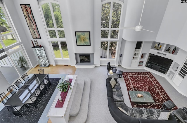 520 Sail Point Way, Columbia, SC 29212 - living room featuring a towering ceiling, a glass covered fireplace, healthy amount of natural light, and built in shelves
