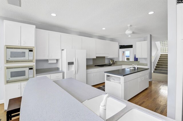 520 Sail Point Way, Columbia, SC 29212 - kitchen featuring white appliances, a sink, a kitchen island with sink, a textured ceiling, and dark wood-type flooring