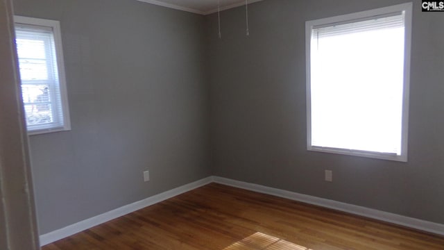 3208 Downes Grove Rd, Columbia, SC 29209 - spare room featuring wood finished floors, ornamental molding, baseboards, and attic access