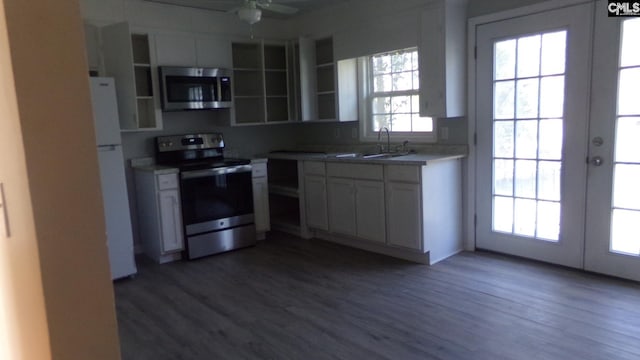 3208 Downes Grove Rd, Columbia, SC 29209 - kitchen with stainless steel appliances, a sink, white cabinetry, light countertops, and dark wood finished floors
