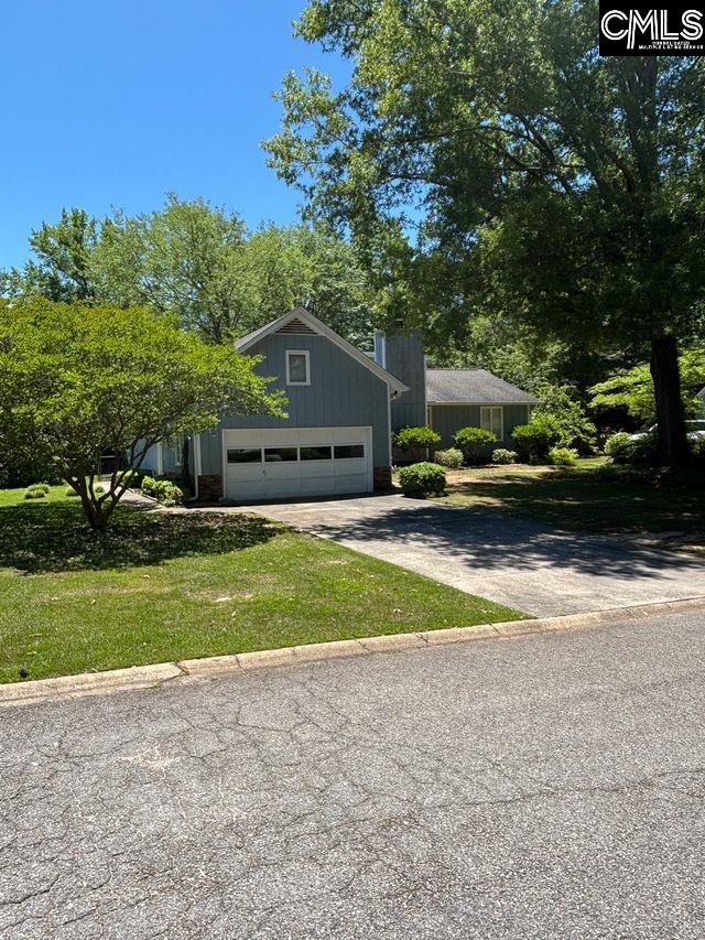 100 Clee Hill Ct, Irmo, SC 29063 - view of front facade featuring concrete driveway, a garage, and a front lawn