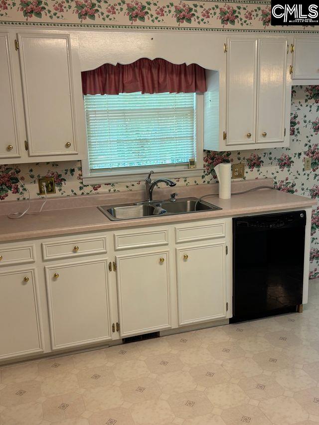 100 Clee Hill Ct, Irmo, SC 29063 - kitchen with black dishwasher, a sink, light countertops, wallpapered walls, and light floors