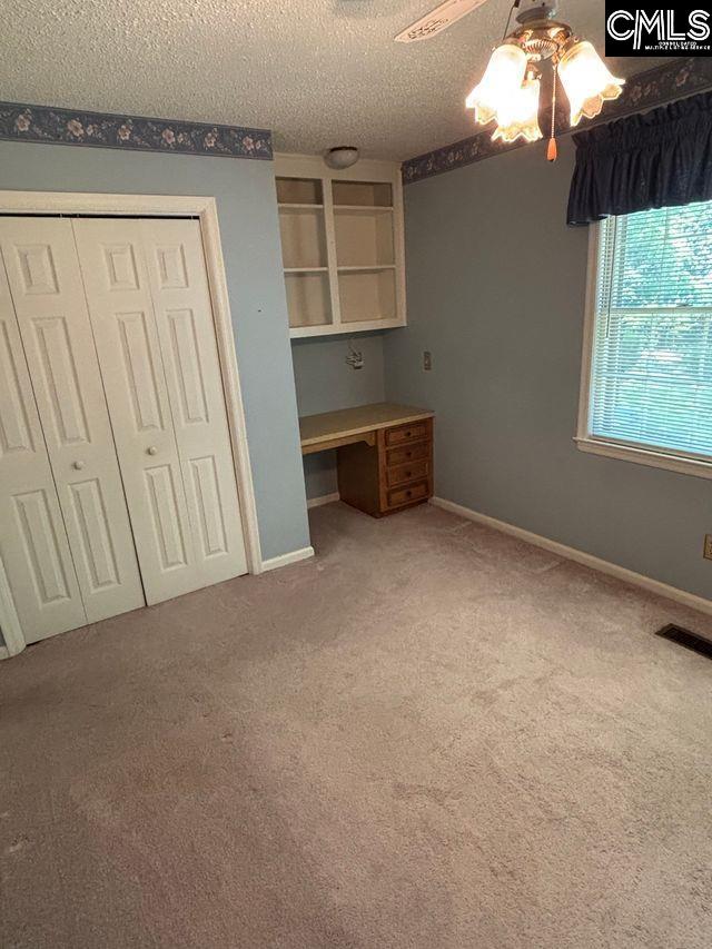 100 Clee Hill Ct, Irmo, SC 29063 - unfurnished bedroom featuring carpet floors, a closet, a ceiling fan, a textured ceiling, and baseboards