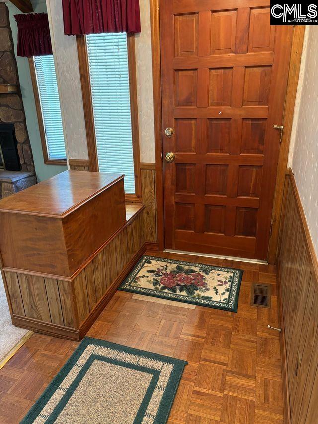 100 Clee Hill Ct, Irmo, SC 29063 - entrance foyer featuring wainscoting and a stone fireplace