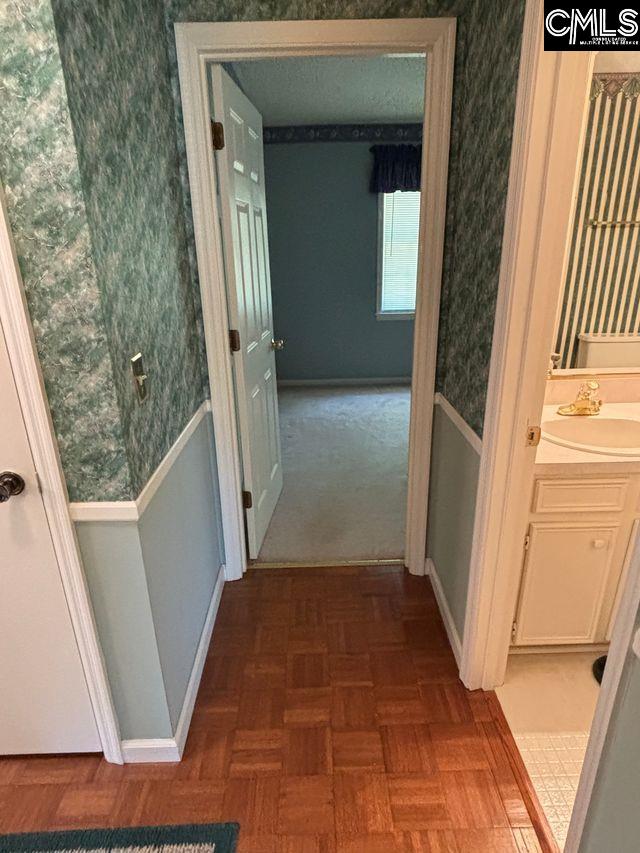 100 Clee Hill Ct, Irmo, SC 29063 - corridor with a sink, wallpapered walls, baseboards, and a wainscoted wall
