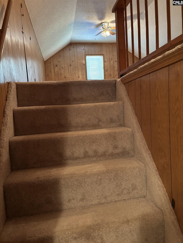 100 Clee Hill Ct, Irmo, SC 29063 - stairs featuring vaulted ceiling, a textured ceiling, ceiling fan, and wood walls