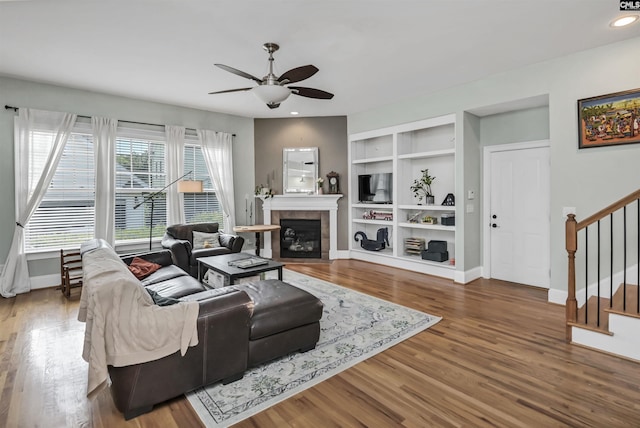 128 Van Der Horst Dr, Columbia, SC 29229 - living area featuring ceiling fan, stairway, baseboards, built in shelves, and wood finished floors
