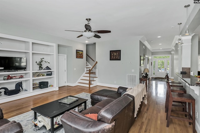 128 Van Der Horst Dr, Columbia, SC 29229 - living room with wood finished floors, a ceiling fan, built in shelves, stairway, and baseboards