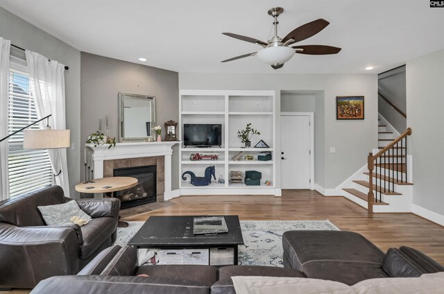128 Van Der Horst Dr, Columbia, SC 29229 - living room featuring stairs, wood finished floors, a ceiling fan, a fireplace, and baseboards