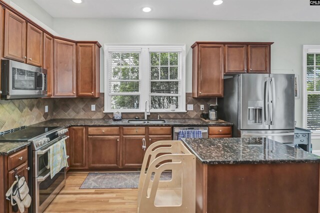 128 Van Der Horst Dr, Columbia, SC 29229 - kitchen featuring appliances with stainless steel finishes, a sink, light wood-style floors, dark stone countertops, and recessed lighting