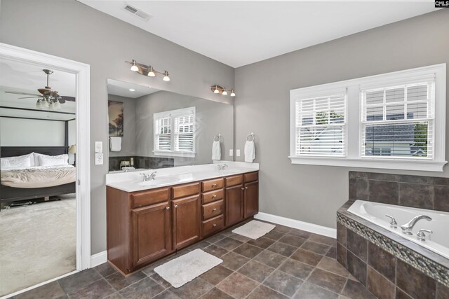 128 Van Der Horst Dr, Columbia, SC 29229 - ensuite bathroom featuring double vanity, a bath, a ceiling fan, and baseboards