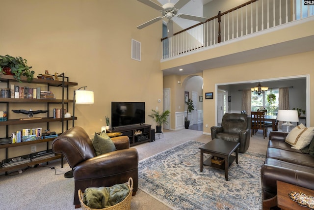 301 Spring Mist Ct, Lexington, SC 29072 - living area featuring carpet, arched walkways, a chandelier, a ceiling fan, and a towering ceiling