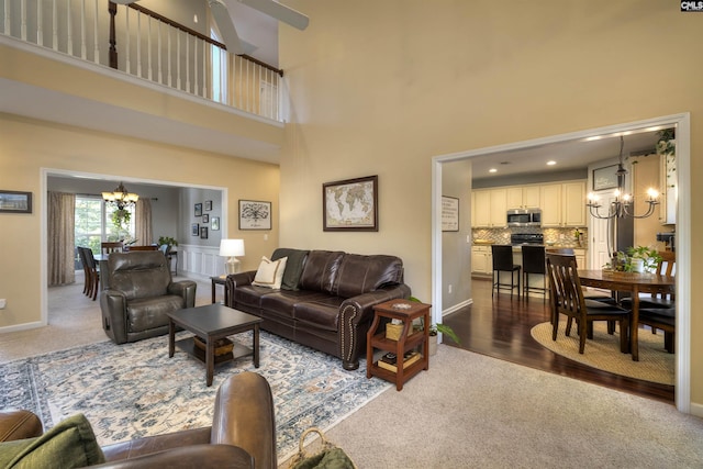 301 Spring Mist Ct, Lexington, SC 29072 - carpeted living room with a chandelier, a high ceiling, ceiling fan, and baseboards