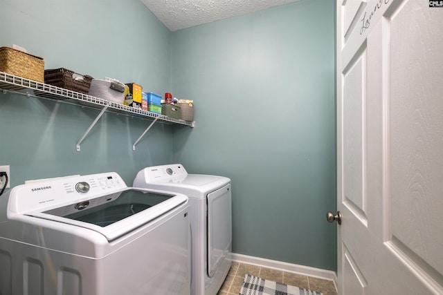 301 Spring Mist Ct, Lexington, SC 29072 - laundry area featuring washer and dryer, baseboards, a textured ceiling, and tile patterned floors