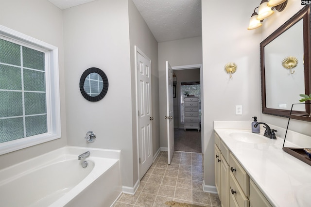 301 Spring Mist Ct, Lexington, SC 29072 - bathroom with vanity, a garden tub, baseboards, plenty of natural light, and a textured ceiling