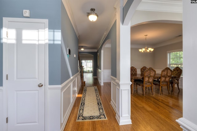 22 Genesis Ln, Camden, SC 29020 - foyer entrance with arched walkways, light wood-type flooring, crown molding, a chandelier, and a wainscoted wall