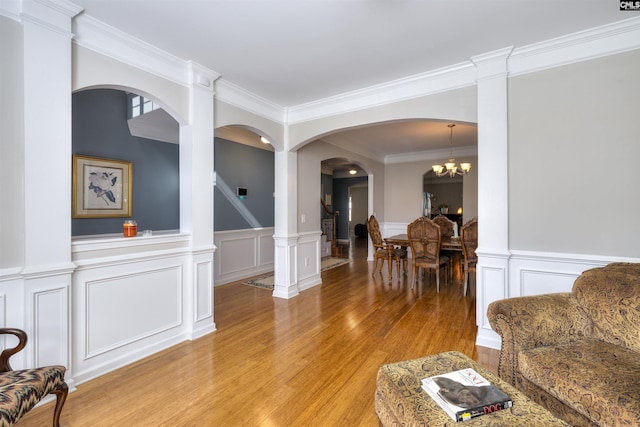 22 Genesis Ln, Camden, SC 29020 - living room with light wood-style flooring, a decorative wall, a wainscoted wall, ornamental molding, and stairs