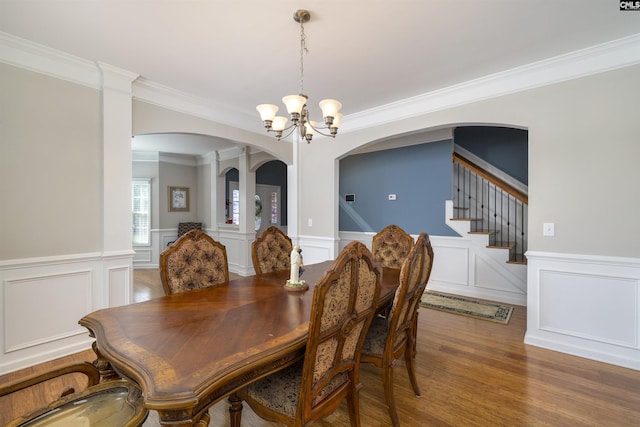 22 Genesis Ln, Camden, SC 29020 - dining area with arched walkways, a chandelier, a decorative wall, a wainscoted wall, and crown molding