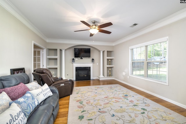 22 Genesis Ln, Camden, SC 29020 - living area with decorative columns, crown molding, a ceiling fan, wood finished floors, and built in features