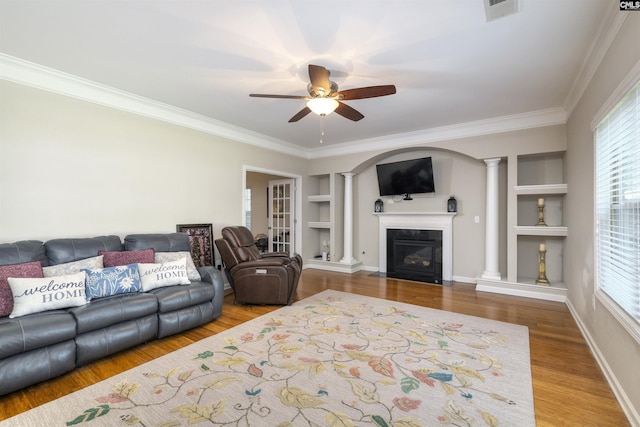 22 Genesis Ln, Camden, SC 29020 - living area with decorative columns, built in features, a ceiling fan, crown molding, and wood finished floors