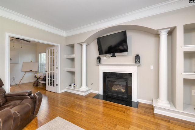 22 Genesis Ln, Camden, SC 29020 - living room with a fireplace with flush hearth, crown molding, ceiling fan, wood finished floors, and decorative columns