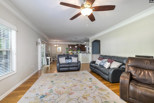 22 Genesis Ln, Camden, SC 29020 - living room featuring ceiling fan, arched walkways, wood finished floors, crown molding, and baseboards