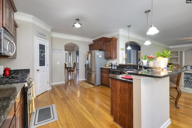 22 Genesis Ln, Camden, SC 29020 - kitchen featuring arched walkways, appliances with stainless steel finishes, a sink, a peninsula, and a breakfast bar area