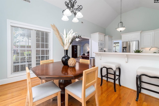 107 Sherborne Ln, Columbia, SC 29229 - dining area featuring a chandelier, light wood-type flooring, and high vaulted ceiling