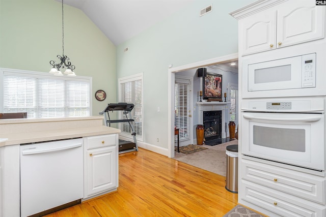 107 Sherborne Ln, Columbia, SC 29229 - kitchen with white appliances, light wood-type flooring, light countertops, white cabinetry, and high vaulted ceiling