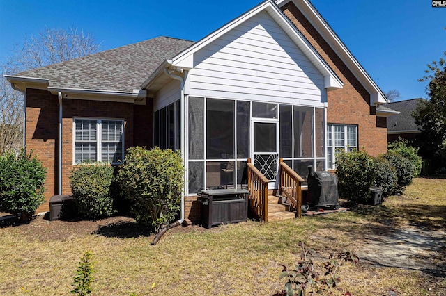 107 Sherborne Ln, Columbia, SC 29229 - back of property with brick siding, a sunroom, a lawn, and a shingled roof