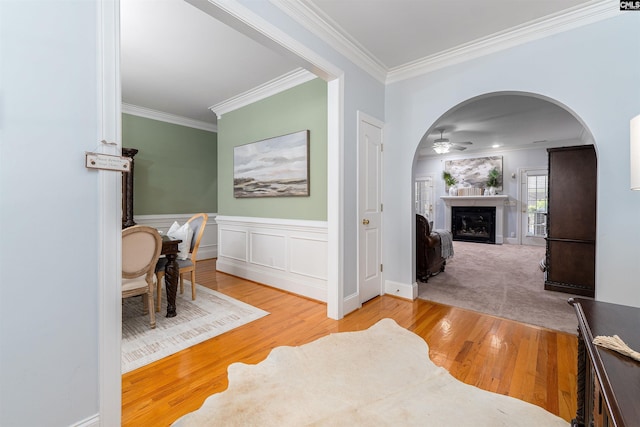 107 Sherborne Ln, Columbia, SC 29229 - hall featuring crown molding, arched walkways, wood finished floors, and wainscoting