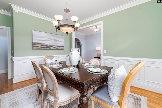 107 Sherborne Ln, Columbia, SC 29229 - dining room with wood finished floors, ornamental molding, a chandelier, wainscoting, and arched walkways