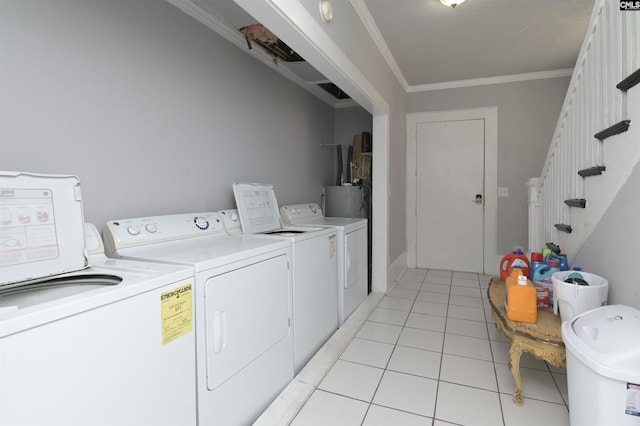 2217 Blossom St, Columbia, SC 29205 - laundry area with independent washer and dryer, ornamental molding, light tile patterned floors, and water heater