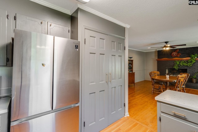 1302 Sunnyhill Dr, Camden, SC 29020 - kitchen featuring freestanding refrigerator, crown molding, light wood finished floors, a ceiling fan, and light countertops