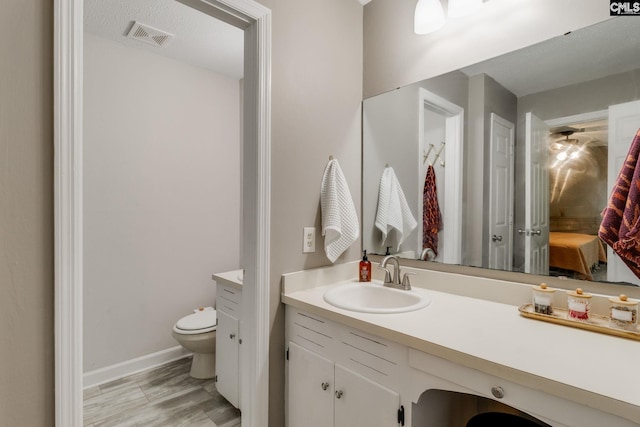 1302 Sunnyhill Dr, Camden, SC 29020 - bathroom with toilet, vanity, ensuite bath, and baseboards